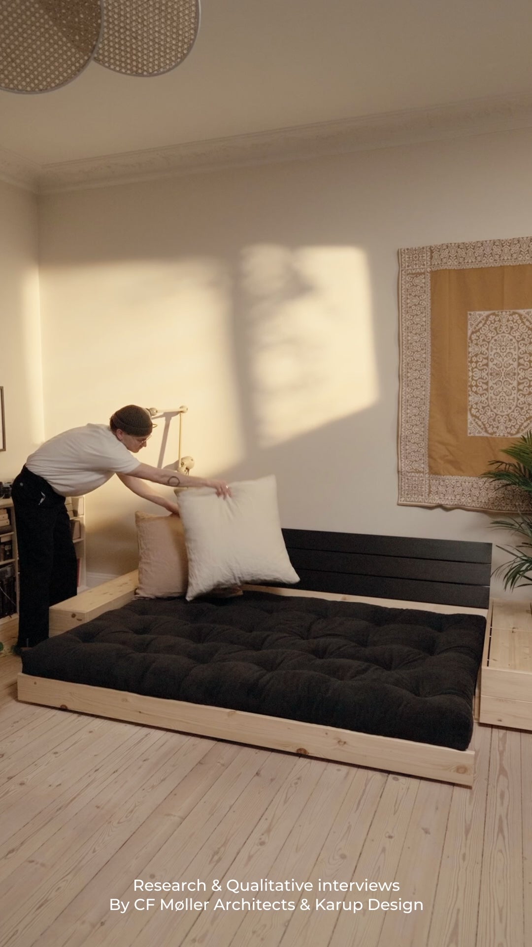 Load video: Convertible sofa with storage in pine with black back and dark gray mattress Base - Karup Design